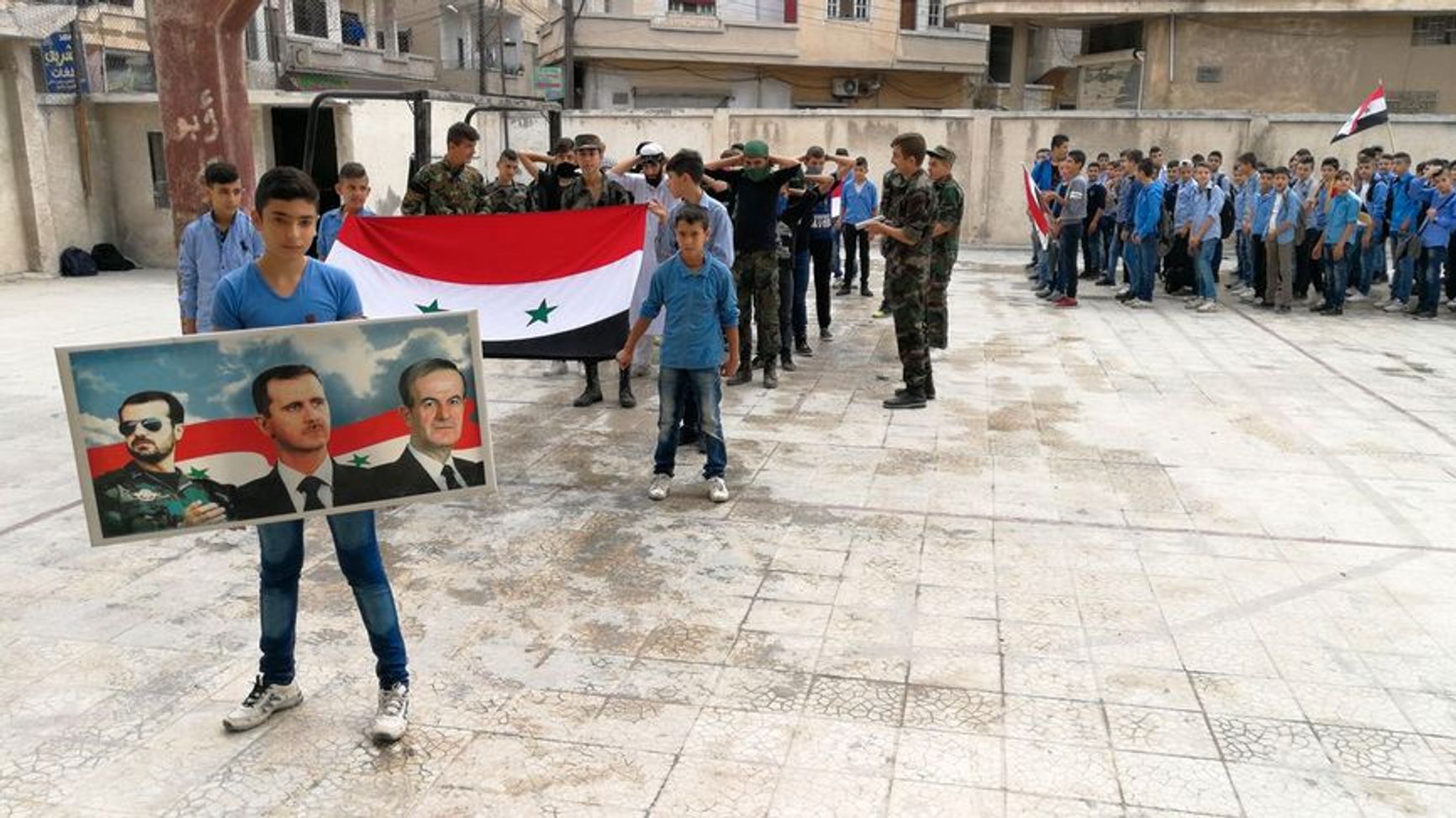 A patriotic lesson in Homs pictured in 2017. Schoolchildren stage a performance titled “Arresting Terrorists,” with students also playing the roles of the terrorists.